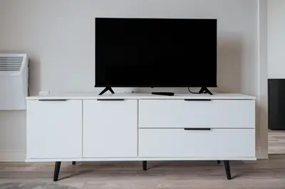 a white entertainment center with a television on it at GuestReady - Delightful getaway in Liverpool in Liverpool