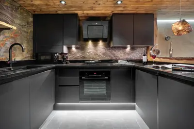 a kitchen with black cabinets and an oven at Coronation Cottages, Modernised 200-Year-Old Lake District Cottage Getaway for Two - Ridgestone in Lindale