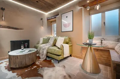 a living room with a couch and a table at Coronation Cottages, Modernised 200-Year-Old Lake District Cottage Getaway for Two - Ridgestone in Lindale