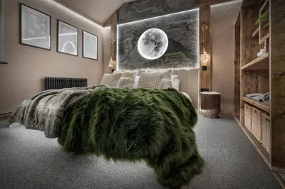 a bedroom with a large bed with a green blanket at Coronation Cottages, Modernised 200-Year-Old Lake District Cottage Getaway for Two - Ridgestone in Lindale