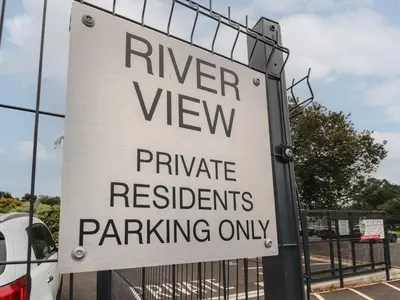 a sign that reads river view private residents parking only at River View in Preston