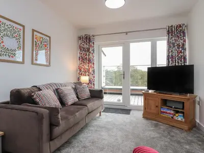 a living room with a couch and a flat screen tv at River View in Preston