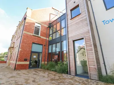 a brick building with glass doors on the side at River View in Preston