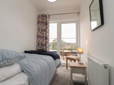 a bedroom with a bed and a window and a table at River View in Preston