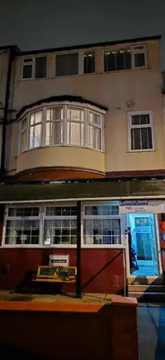 a large building with a store front with at The Sandalwood Hotel in Blackpool