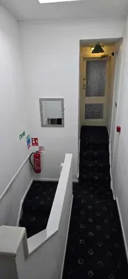 a hallway with a stairway leading to a bathroom at The Sandalwood Hotel in Blackpool