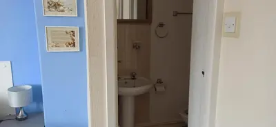 a bathroom with a sink and a toilet at The Sandalwood Hotel in Blackpool
