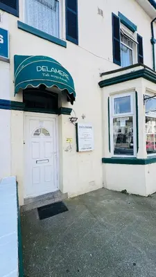 a building with a door and a sign on it at Delamere Hotel in Blackpool