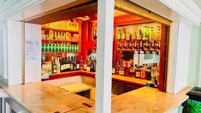 a bar with a lot of bottles of alcohol at Delamere Hotel in Blackpool