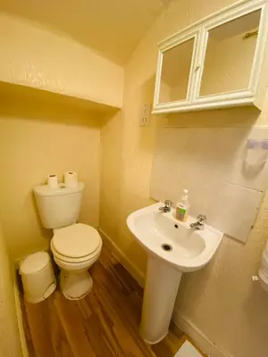 a bathroom with a toilet and a sink at Delamere Hotel in Blackpool