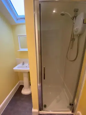 a bathroom with a shower and a sink at Delamere Hotel in Blackpool