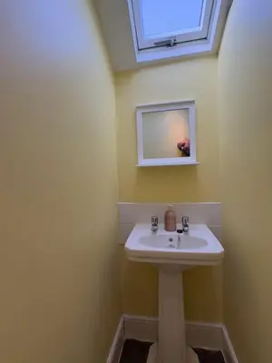 a bathroom with a sink and a skylight at Delamere Hotel in Blackpool