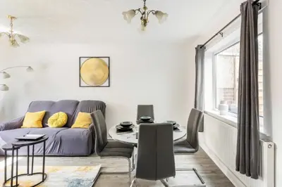 a living room with a couch and a table at 3 Bed House - Sleeps 5 - Parking - Garden - Wifi in Blackburn