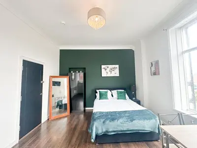 a bedroom with a bed and a mirror at The Valley Inn Liverpool in Liverpool