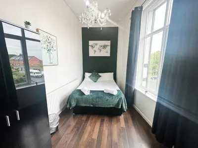 a small bedroom with a bed and a window at The Valley Inn Liverpool in Liverpool