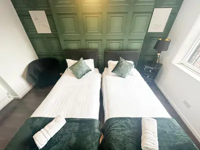 two beds sitting next to each other in a room at The Valley Inn Liverpool in Liverpool