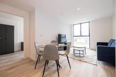 a living room with a table and chairs and a couch at GuestReady - Lux getaway in Liverpool in Liverpool
