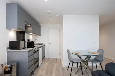 a kitchen and dining room with a table and chairs at GuestReady - Stunning studio in Liverpool in Liverpool