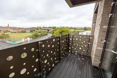 a balcony with a fence with a view of a city at GuestReady - Stunning studio in Liverpool in Liverpool