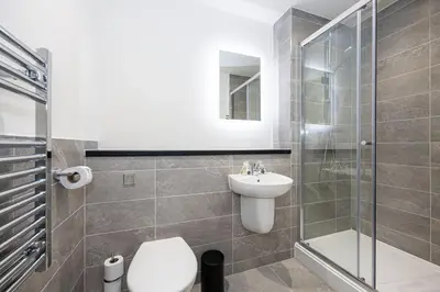 a bathroom with a toilet and a sink and a shower at GuestReady - Stunning studio in Liverpool in Liverpool