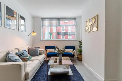 a living room with a couch and a table at Modern 4bedroom Spacious Family Home in Liverpool