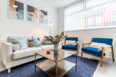 a living room with a couch and two chairs at Modern 4bedroom Spacious Family Home in Liverpool