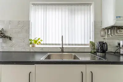 a kitchen with a sink and a window at Modern 4bedroom Spacious Family Home in Liverpool
