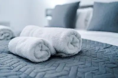 a stack of towels on a bed at Victoria Mill by Staycay in Wigan
