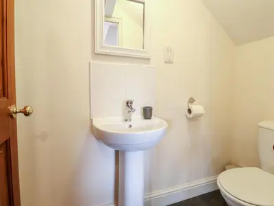 a bathroom with a sink and a toilet at Church View in Grange Over Sands