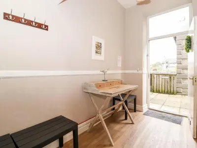 a room with a table and a bench and a window at Church View in Grange Over Sands