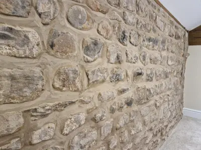 a stone wall in a house at The Hamilton luxury holiday let's- The Coach House with hot tub in Scorton