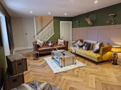 a living room with two couches and a table at The Hamilton luxury holiday let's- The Coach House with hot tub in Scorton
