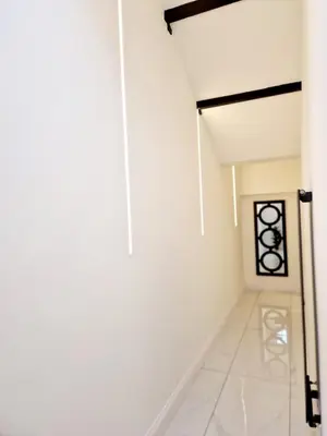 a hallway with a white wall and a door at The Hamilton luxury holiday let's- Holly Barn in Scorton