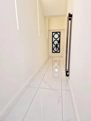a hallway with white walls and a white tile floor at The Hamilton luxury holiday let's- Holly Barn in Scorton