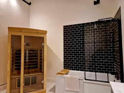a room with a glass cabinet and a black tile wall at The Hamilton luxury holiday let's- Holly Barn in Scorton