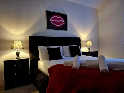a bedroom with a large bed with two night stands at The Hamilton luxury holiday let's- Holly Barn in Scorton