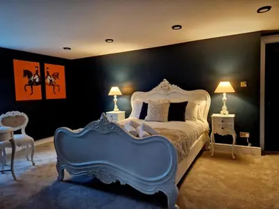 a bedroom with a large bed with a blue headboard at Hamilton-The Alexander suite luxury holiday Let's in Scorton