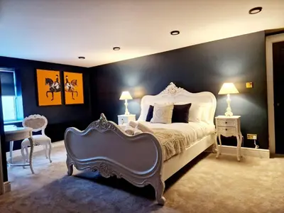 a bedroom with a large bed and a chair at Hamilton-The Alexander suite luxury holiday Let's in Scorton