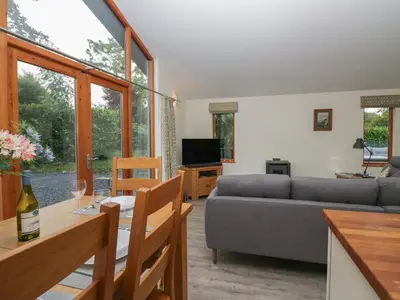 a living room with a couch and a table at Bay Tree Lodge in Grange Over Sands