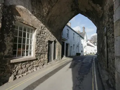 an archway in a stone building on a street at Bay Tree Lodge in Grange Over Sands