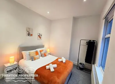 a bedroom with a bed with two towels on it at 31 Westmorland Street by Prestige Properties SA in Barrow in Furness