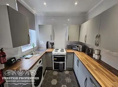 a small kitchen with a stove and a sink at 31 Westmorland Street by Prestige Properties SA in Barrow in Furness
