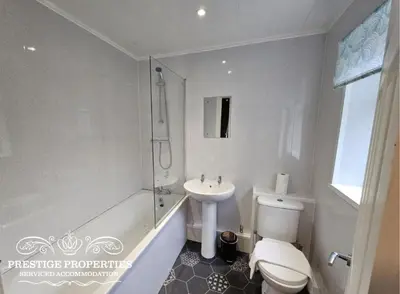 a bathroom with a toilet and a sink and a shower at 31 Westmorland Street by Prestige Properties SA in Barrow in Furness