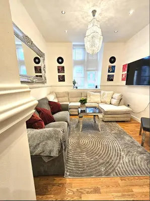 a living room with a couch and a table at Sidemersey Livings - Spacious Loft for bigger groups - Very Central and Cosy in Liverpool