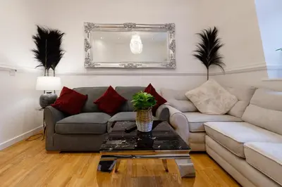 a living room with a couch and a table at Sidemersey Livings - Spacious Loft for bigger groups - Very Central and Cosy in Liverpool
