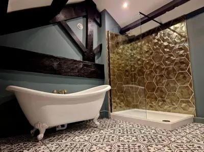 a bathroom with a bath tub and a shower at Hamilton-The Cruck Luxury Let in Scorton
