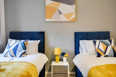 two beds sitting next to each other in a bedroom at Beautiful Stylish 2BD Flat - Free Parking 30 Percent Off Long term bookings in Wallasey