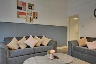 a living room with two couches and a table at Beautiful Stylish 2BD Flat - Free Parking 30 Percent Off Long term bookings in Wallasey