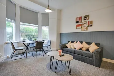 a living room with a couch and a table at Beautiful Stylish 2BD Flat - Free Parking 30 Percent Off Long term bookings in Wallasey
