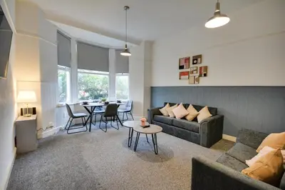 a living room with a couch and a table at Beautiful Stylish 2BD Flat - Free Parking 30 Percent Off Long term bookings in Wallasey